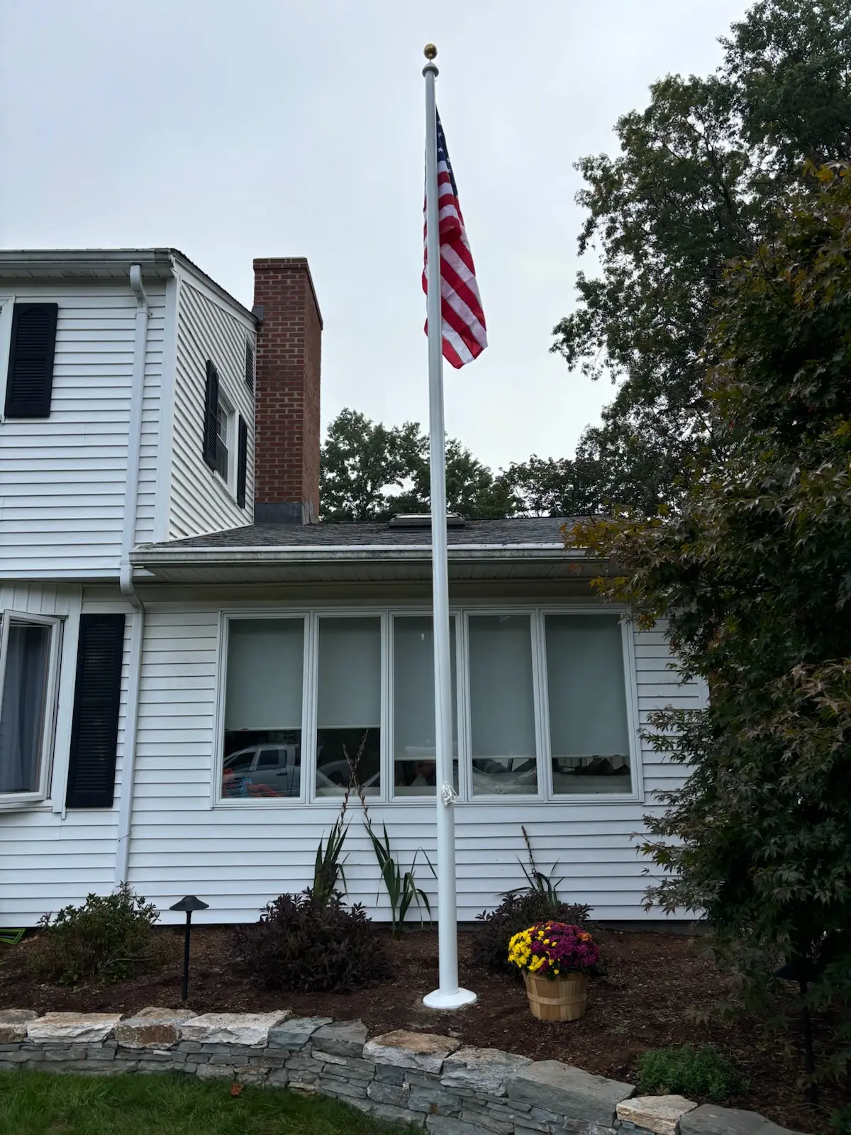 Flagpole installation at a house